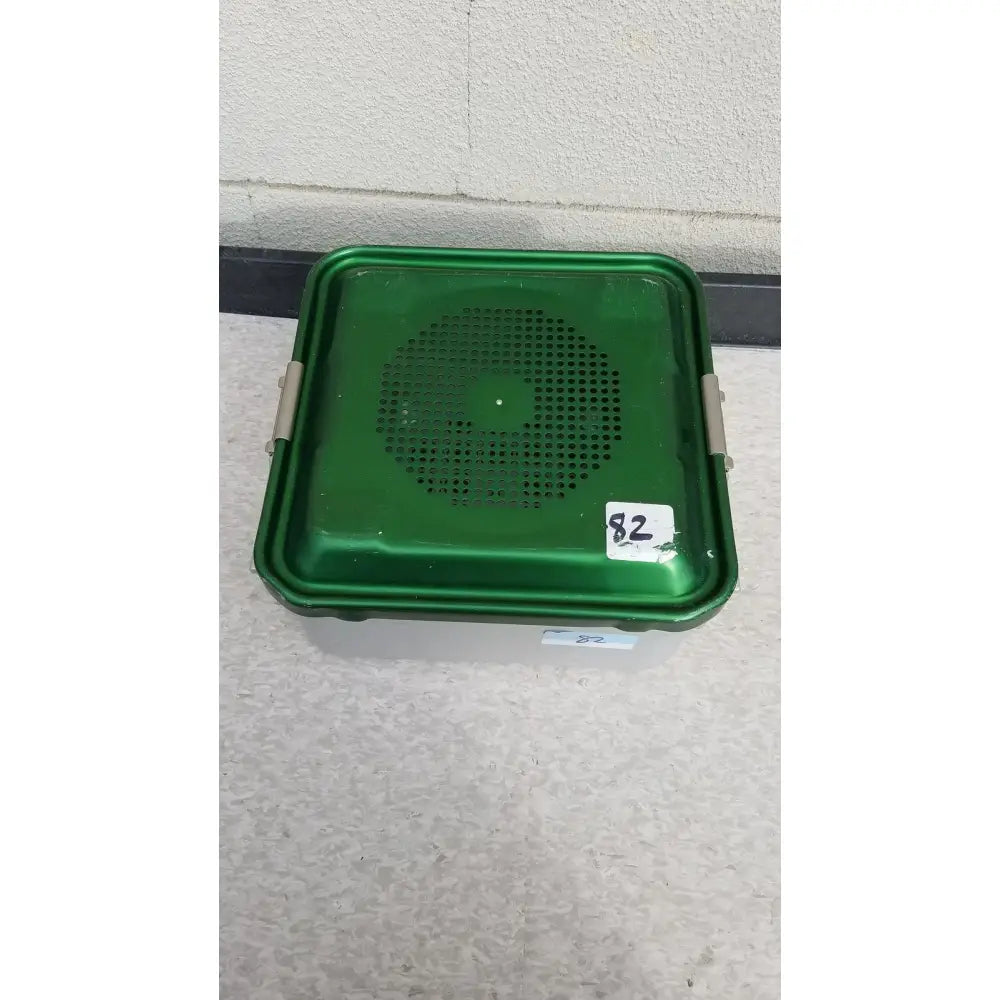Green plastic aesculap jn341 sterilization container with perforated lid and metallic latches for secure storage