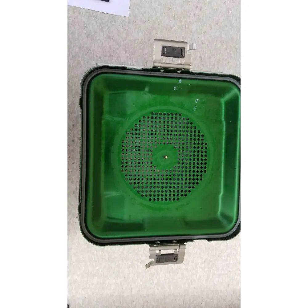 Green plastic aesculap jn341 sterilization container with black rim and two metallic side latches for secure closure