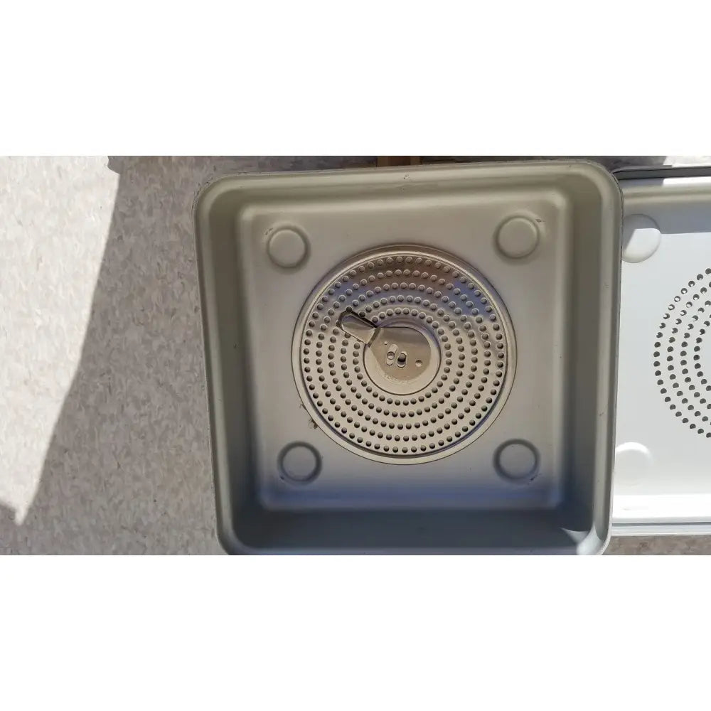 Aesculap jn342 sterilization gray plastic container with circular perforated drain cover and four rounded feet