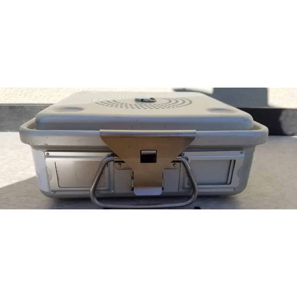 Silver metallic aesculap jn342 sterilization container with sturdy handle and reinforced latches for secure closure