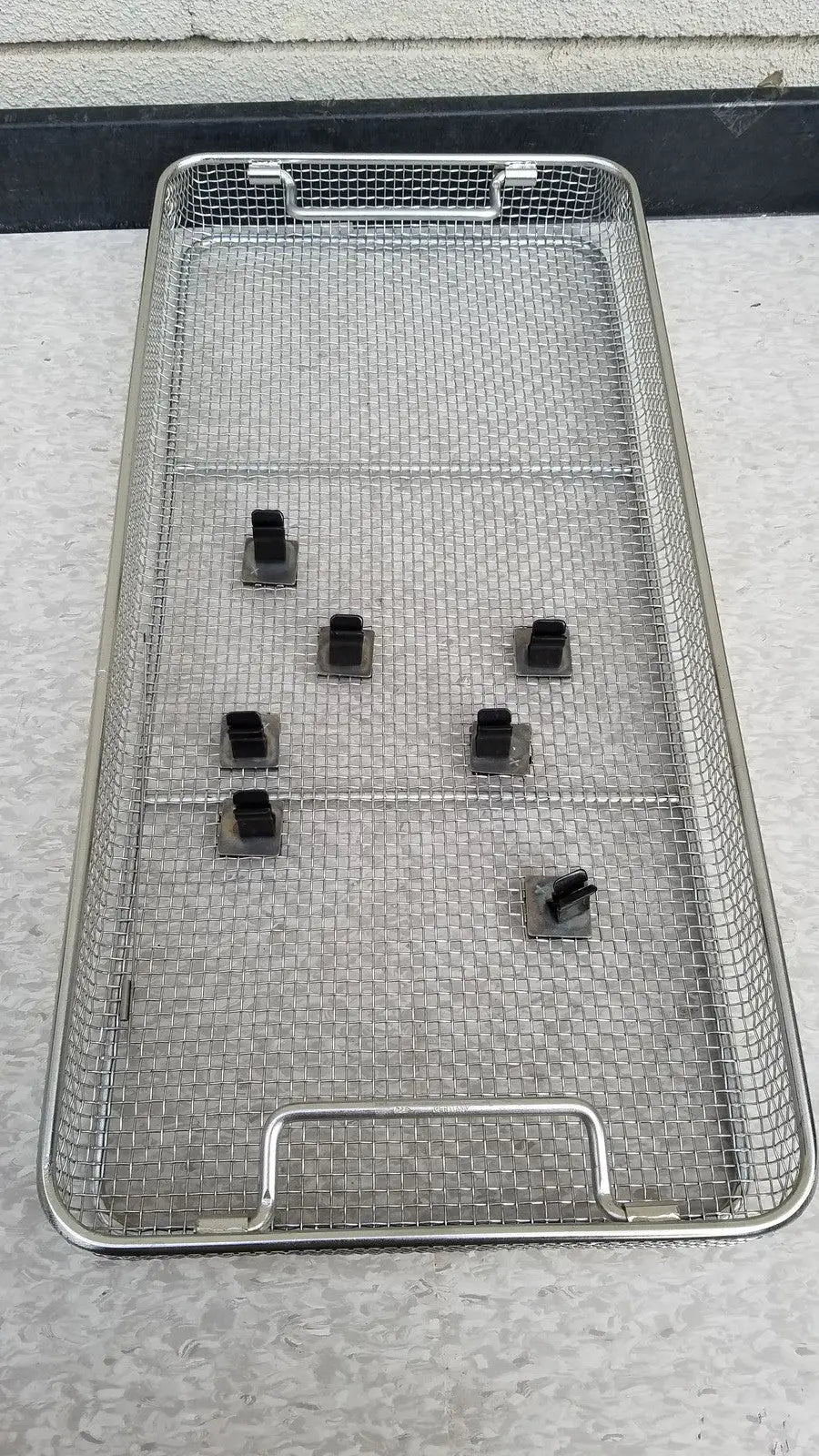 Aesculap JN821 sterilization case stainless steel mesh tray with black plastic clips for instrument storage