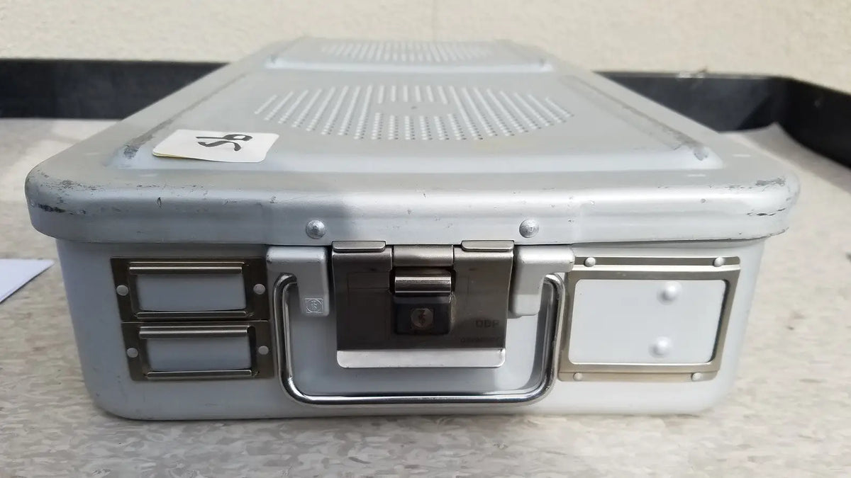 Gray metallic aesculap jn821 sterilization case with sturdy handle silver latches and lock mechanism for instruments