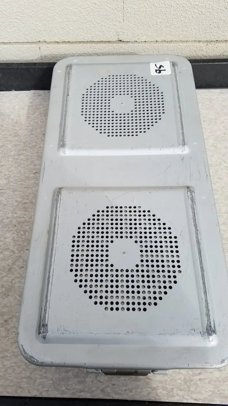 Gray metal aesculap jn821 sterilization case instrument tray with two circular perforated grilles for sterilization