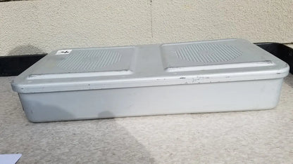 Gray plastic rectangular aesculap jn821 sterilization case instrument tray with two perforated grilles on top surface