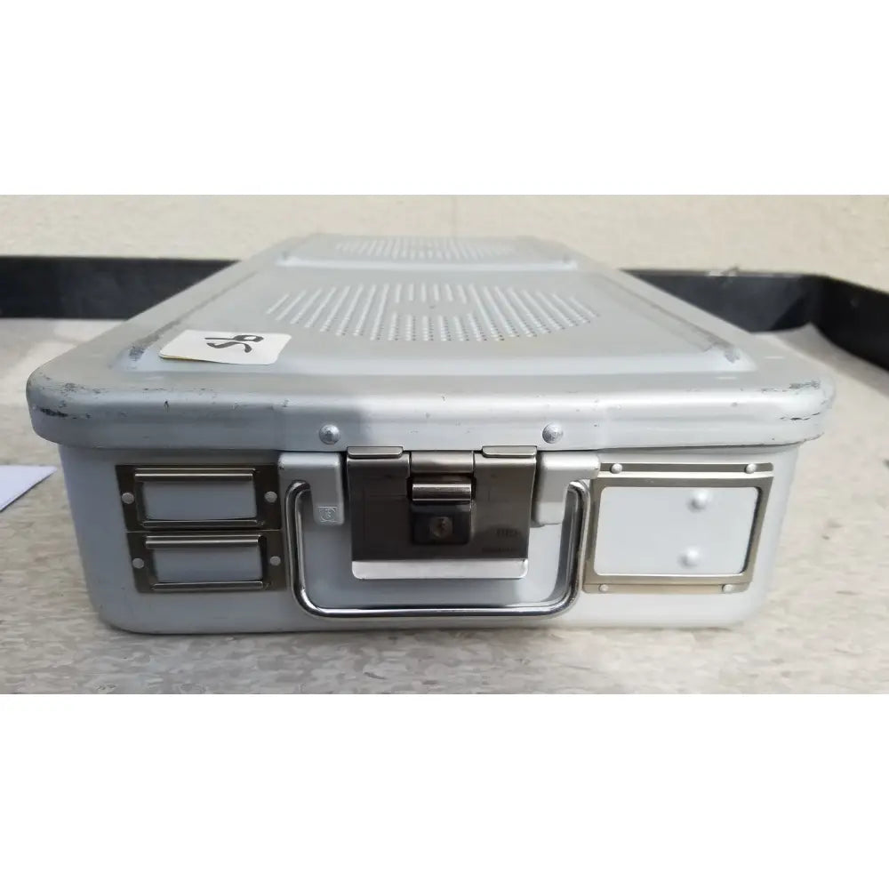 Gray metallic aesculap jn821 sterilization case with sturdy handle silver latches and lock mechanism for instruments