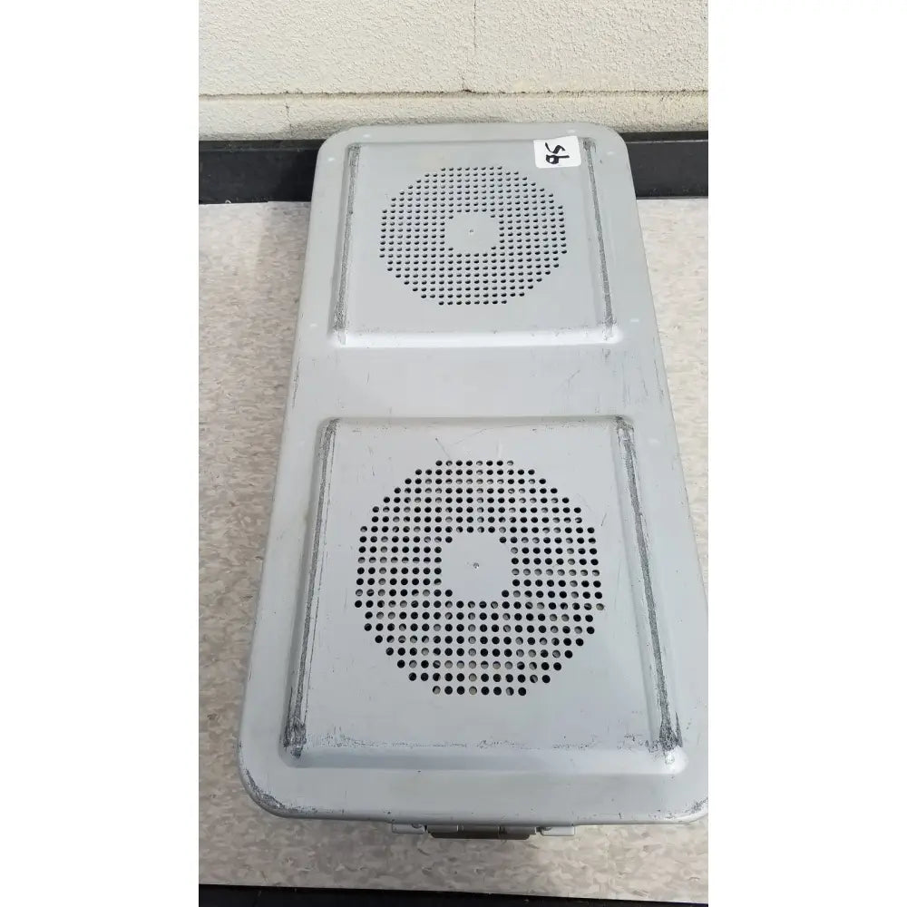 Gray metal aesculap jn821 sterilization case instrument tray with two circular perforated grilles for sterilization