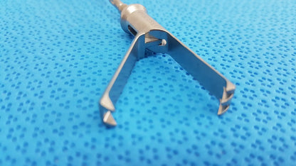 Stainless steel aesculap laparoscopic grasper model p0623r with textured metallic finish and two angled prongs