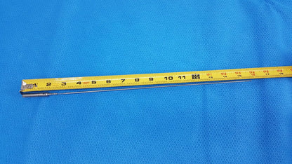 A yellow measuring tape with black markings and metal end on blue surface for aesculap laparoscopic grasper model p0623r