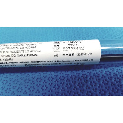 A black cylindrical aesculap laparoscopic grasper ref pm981r with a white label showing product details and brand name