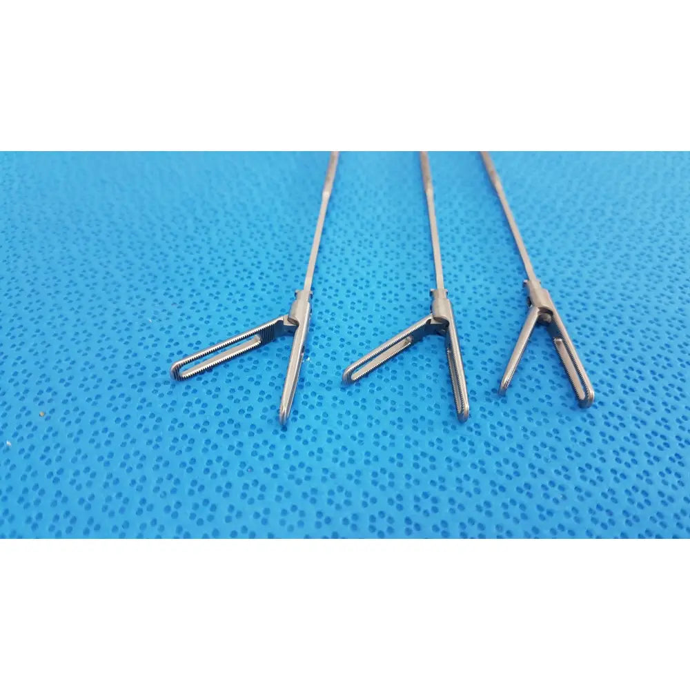 Three polished stainless steel aesculap laparoscopic instruments model 33310 with precision jaws for reuse medical use