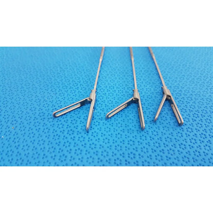 Three polished stainless steel aesculap laparoscopic instruments model 33310 with precision jaws for reuse medical use