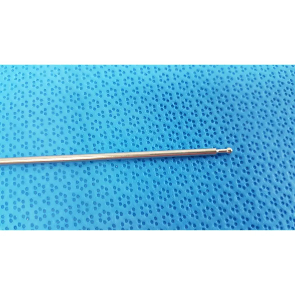 A slender metallic aesculap laparoscopic instrument model pm 716r crochet hook with polished gold finish and rounded tip