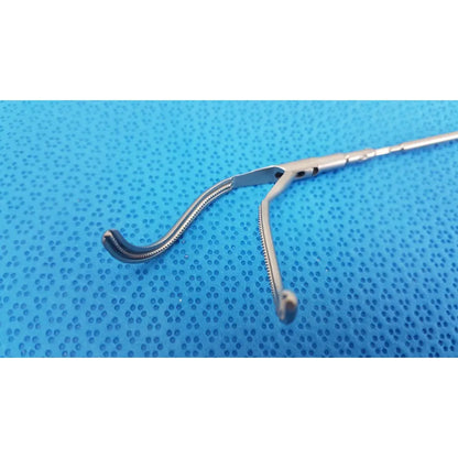 Silver aesculap laparoscopic instrument model pm 716r with curved serrated jaw and long handle for surgical use