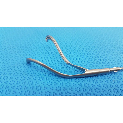 Silver surgical retractor with curved serrated edge and smooth handle aesculap laparoscopic instrument model pm 716r