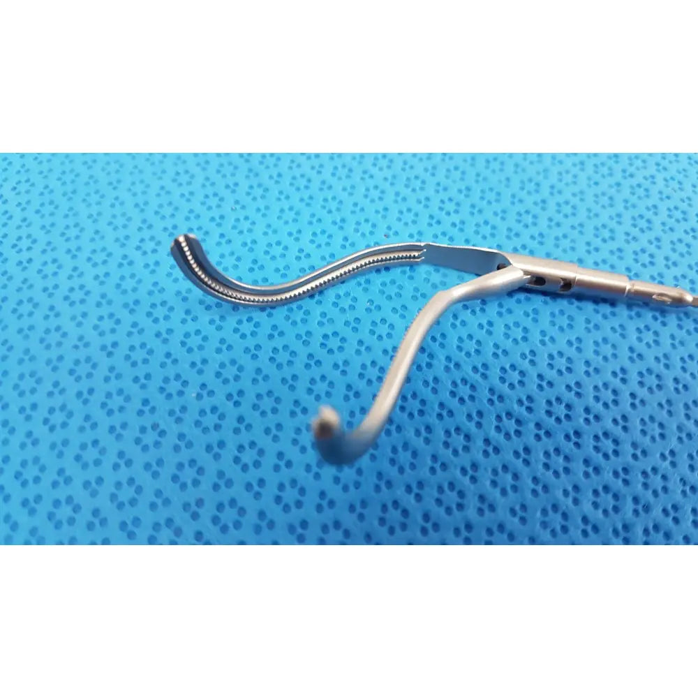 Silver aesculap laparoscopic instrument model pm 716r with curved serrated jaw and smooth handle for precise surgical use