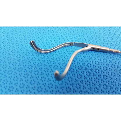 Silver aesculap laparoscopic instrument model pm 716r with curved serrated jaw and smooth handle for precise surgical use