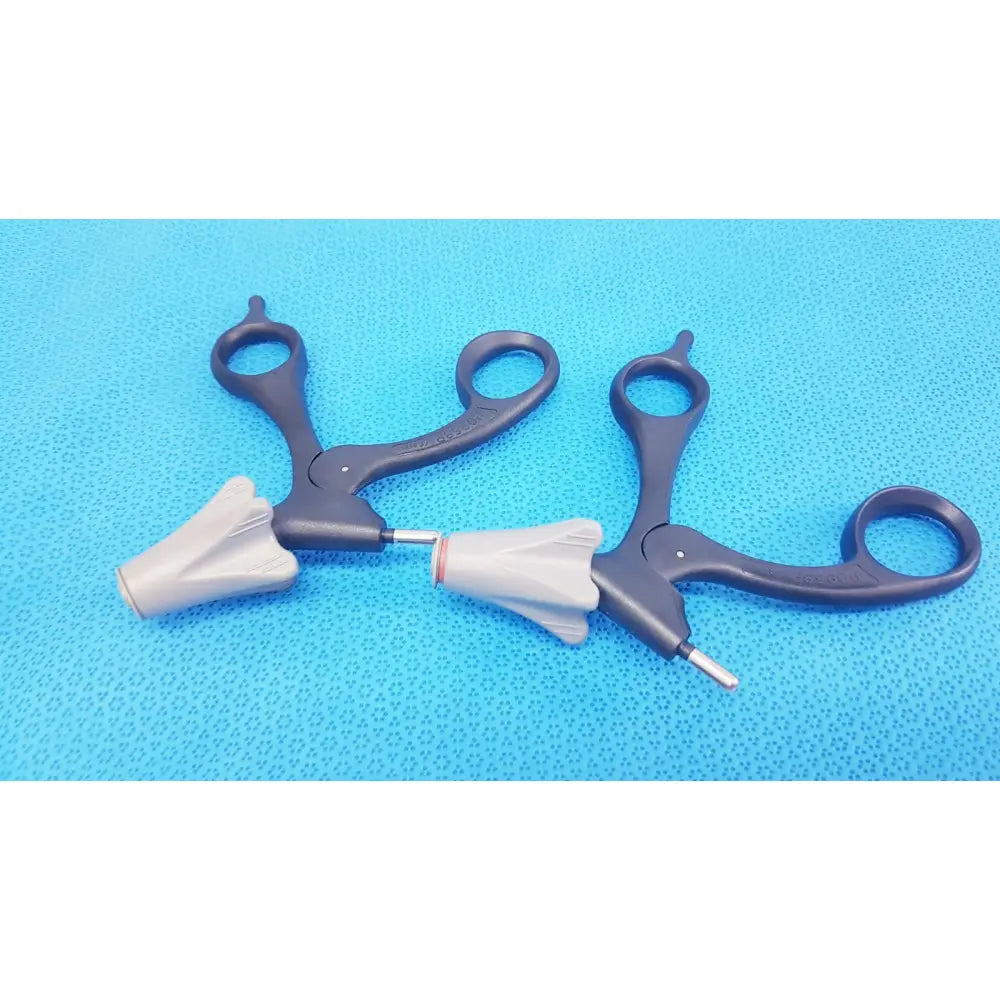 Black and gray surgical forceps with ergonomic handles and textured grips from the Aesculap p0958r quick snap lot of 2