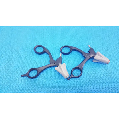 Black Aesculap p0958r quick snap non-ratchet laparoscopic scissors with white cone-shaped tips on blue surface