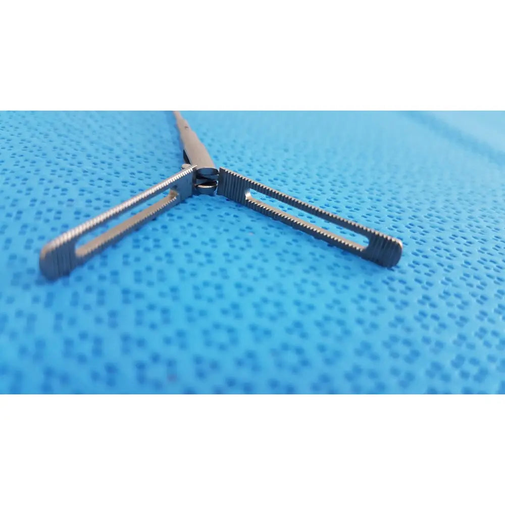 Silver aesculap pm618r laparoscopic instrument with textured ridged jaws and sleek metallic finish surgical forceps