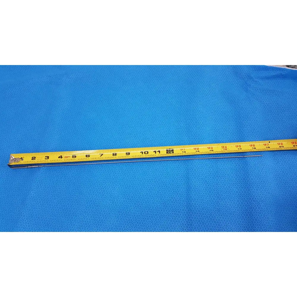 Yellow measuring tape with black markings and metallic end on blue surface beside aesculap pm618r laparoscopic instrument