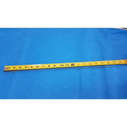 Yellow measuring tape with black markings and metallic end on blue surface beside aesculap pm618r laparoscopic instrument