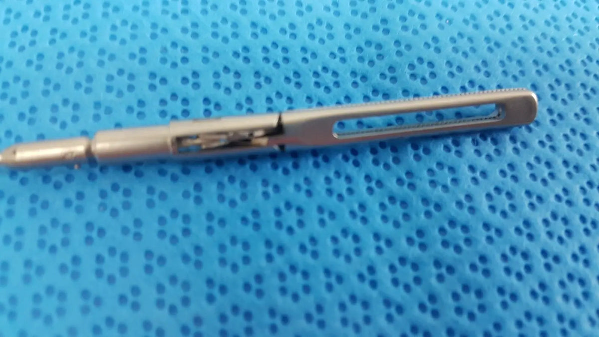 Silver metallic aesculap pm618r laparoscopic instrument pen with textured grip and retractable mechanism
