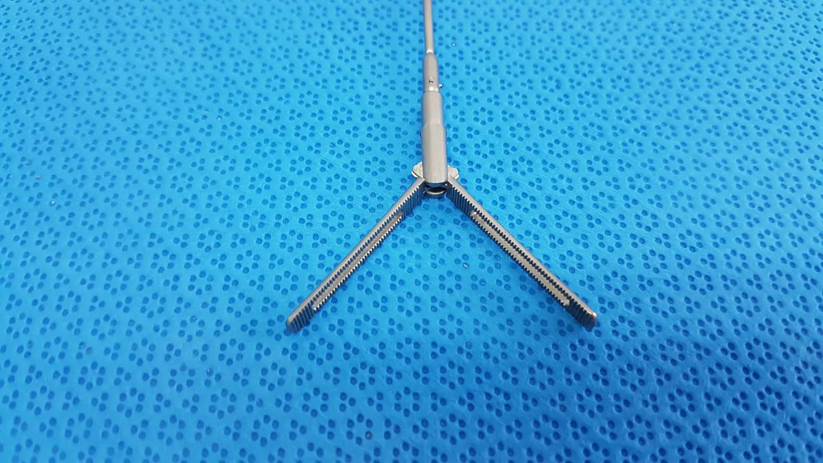 Silver metallic aesculap pm618r laparoscopic instrument with three prongs and central shaft for surgical use