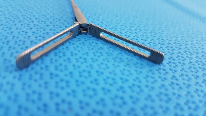 Silver aesculap pm618r laparoscopic instrument with textured ridged jaws and sleek metallic finish surgical forceps