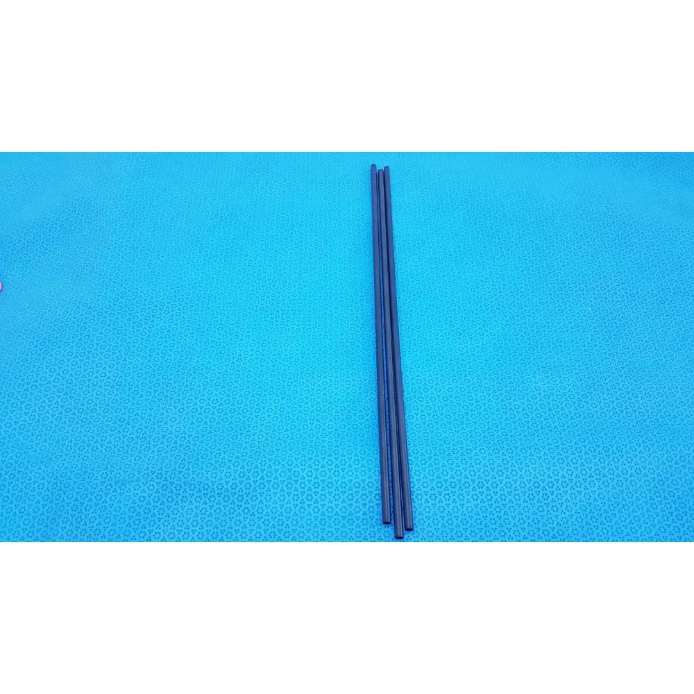 Three slender black aesculap pm973r insulated outer tubes 5 x 310 mm lie parallel on a bright blue textured surface