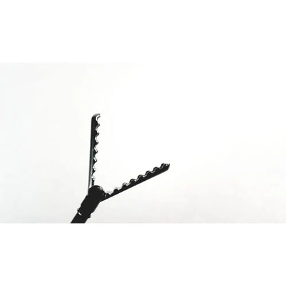 Black aesculap precision dissector surgical instrument with serrated edges and smooth handle for minimally invasive surgery