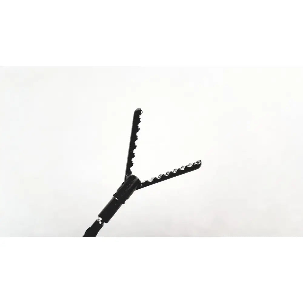 Aesculap precision dissector surgical instrument in black with serrated v-shaped jaws and textured handle for precise dissection