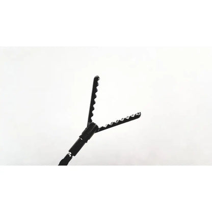 Aesculap precision dissector surgical instrument in black with serrated v-shaped jaws and textured handle for precise dissection