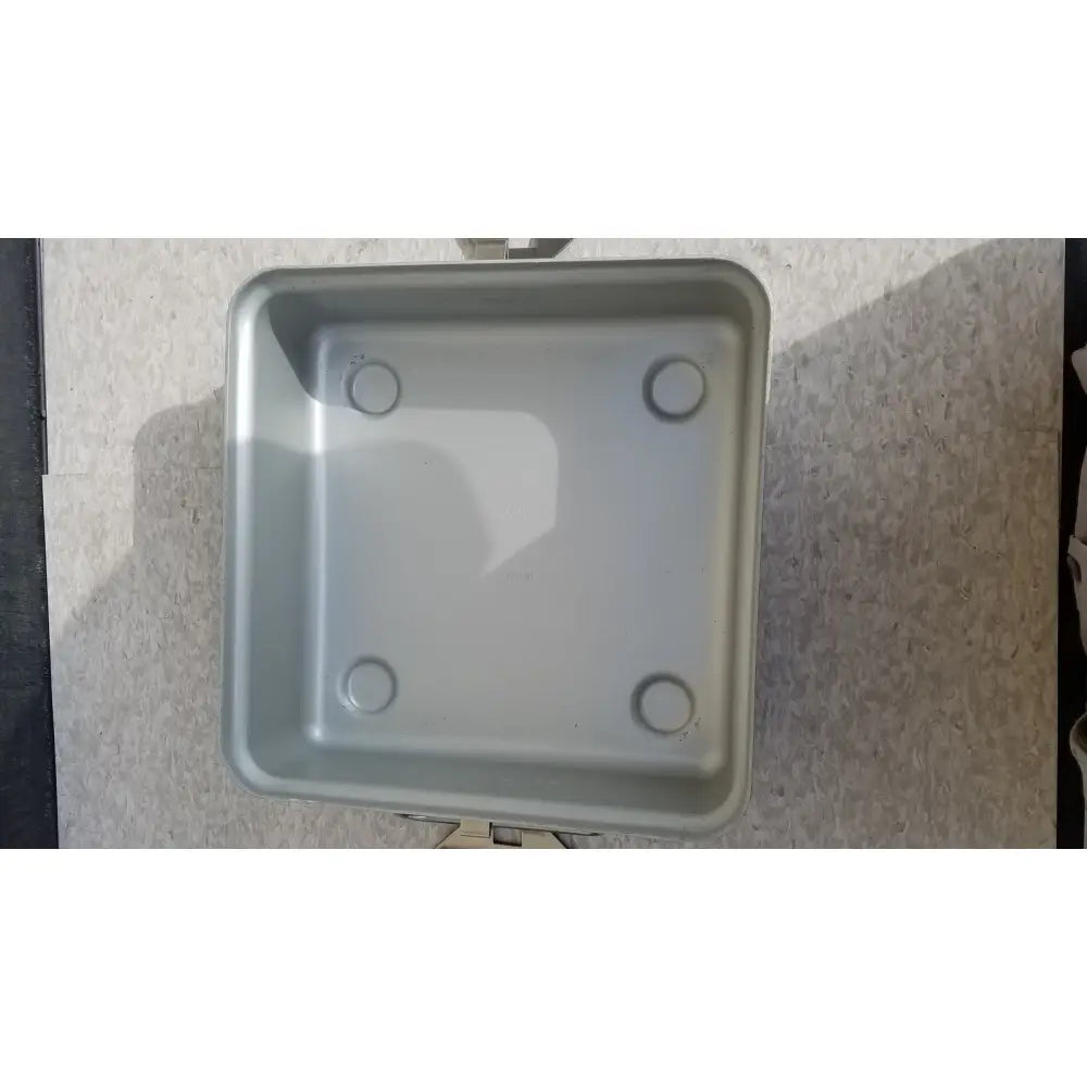 Silver rectangular aesculap sterilization container without lid with rounded corners and four circular indentations