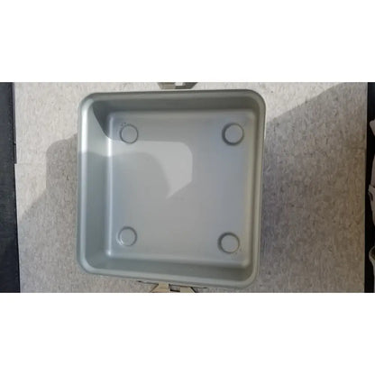 Silver rectangular aesculap sterilization container without lid with rounded corners and four circular indentations