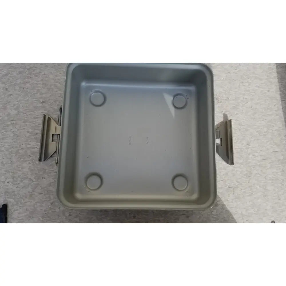 Silver-colored square metal aesculap sterilization container without lid featuring two side handles and four circular indentations