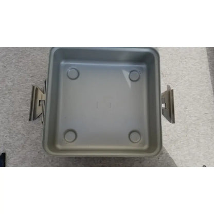 Silver-colored square metal aesculap sterilization container without lid featuring two side handles and four circular indentations