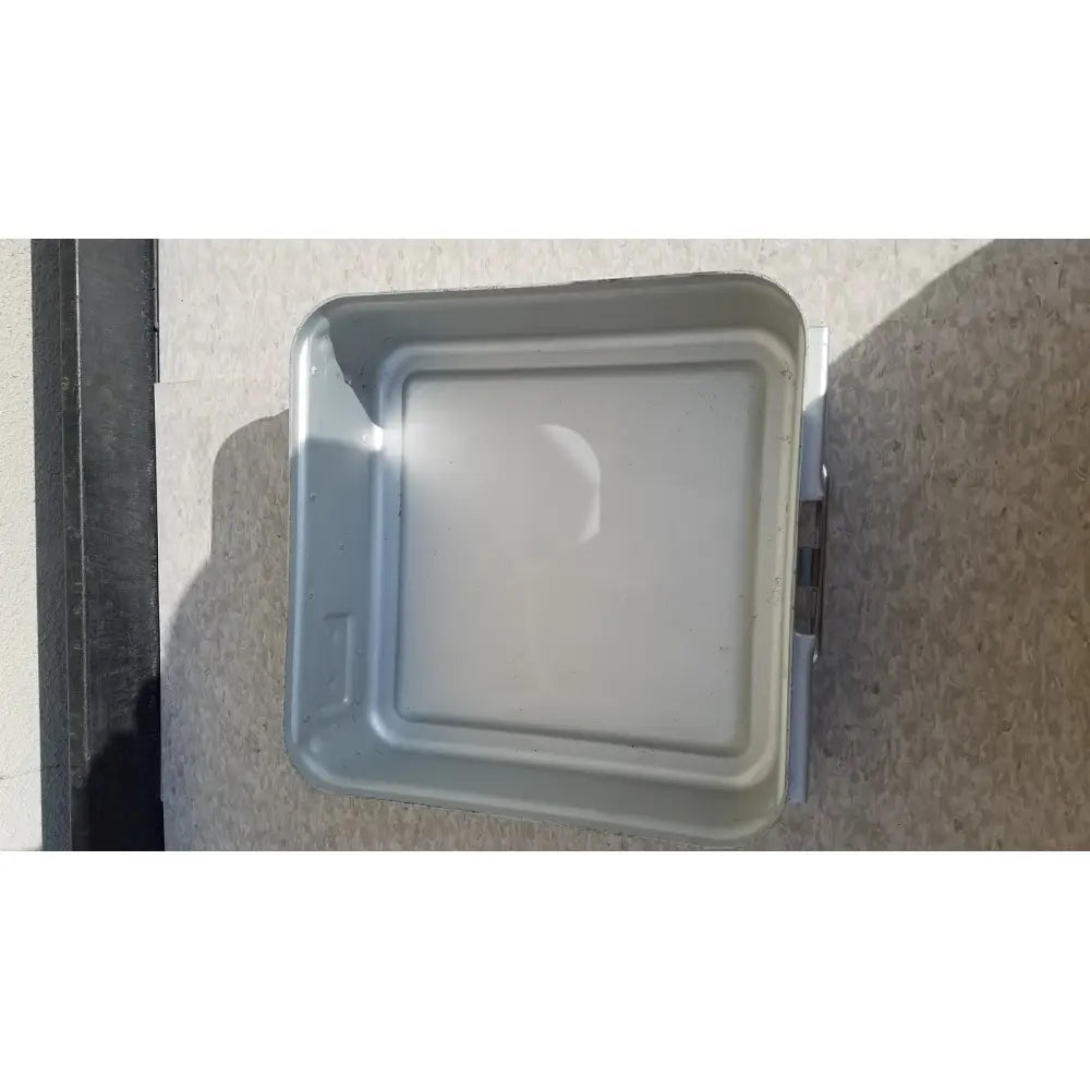 Gray metal aesculap sterilization container without lid featuring a square raised lid and visible side hinges