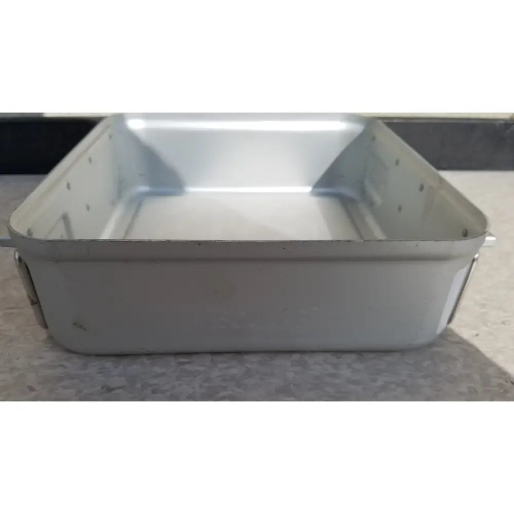 Silver-colored rectangular metal aesculap sterilization container without lid with riveted edges and slightly worn finish