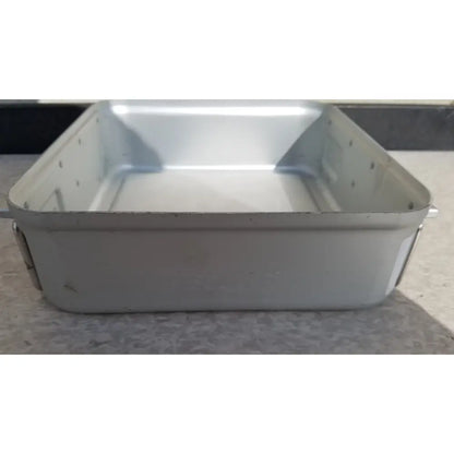 Silver-colored rectangular metal aesculap sterilization container without lid with riveted edges and slightly worn finish