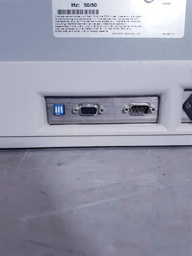 White plastic affymetrix genechip fluidics station 450 back with three ports including glowing blue usb and two black vga connectors