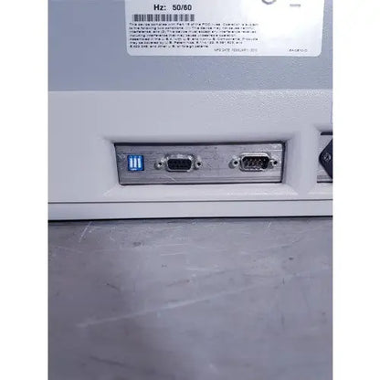 White plastic affymetrix genechip fluidics station 450 back with three ports including glowing blue usb and two black vga connectors