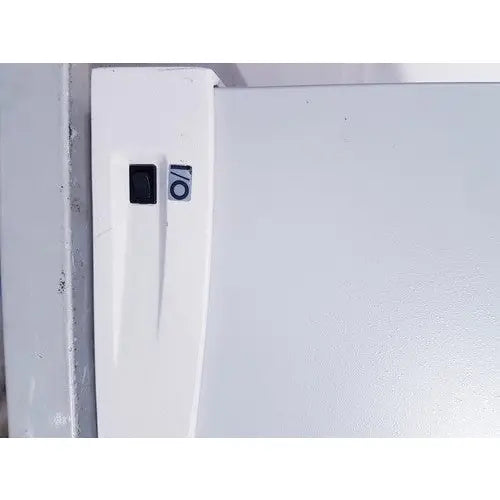White refrigerator door with black power switch and circular sticker on affymetrix genechip fluidics station 450