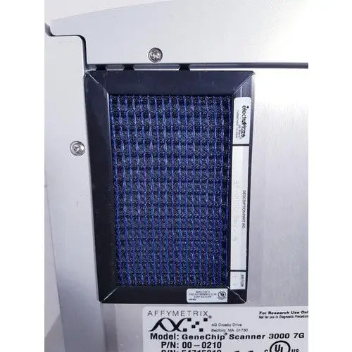 Blue mesh filter panel in a black frame mounted on silver affymetrix genechip scanner 3000 housing for reuse medical applications