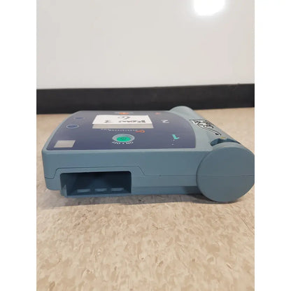 Blue-gray agilent heartstream fr2 semi automatic patient monitor showing green power button and labeled ports