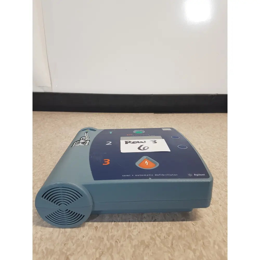 Blue agilent heartstream fr2 semi automatic defibrillator with control panel and speaker grille for patient monitoring