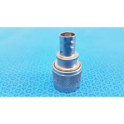 Silver agilent n-type female to bnc male rf coaxial adapter with knurled grip threaded barrel and bnc male connector