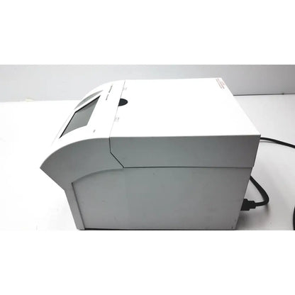 White plastic agilent surecycler 8800 touch screen thermal cycler with small screen and black power cord visible