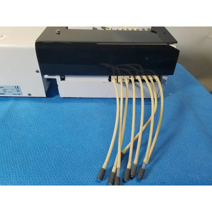 Black and white Agilent Technologies 810 peristaltic pump with six beige tubing connectors for reuse medical applications