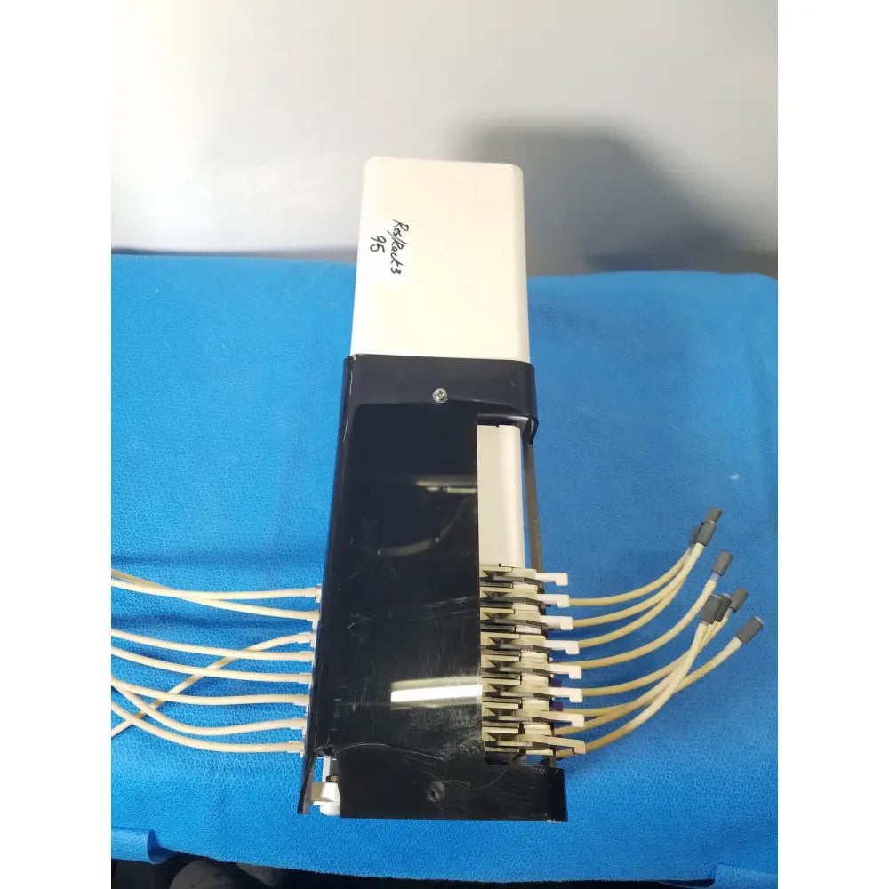 Back side of agilent technologies 810 peristaltic pump with white and black cable management device and beige cables for reuse medical applications