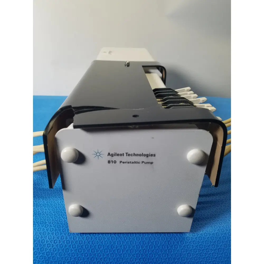 Agilent Technologies 810 peristaltic pump with gray and black metallic body and beige tubing connectors for reuse medical applications